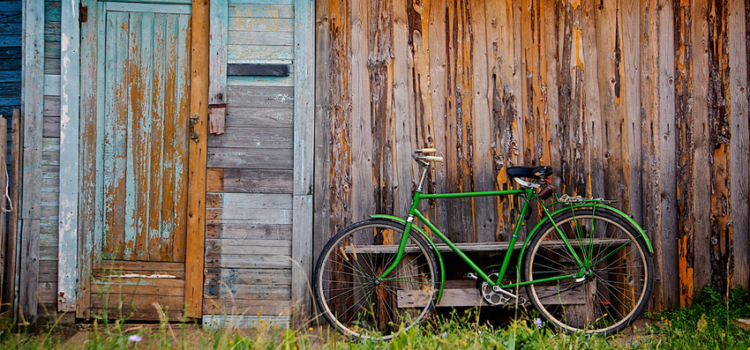 Old wooden wall and green bicycle